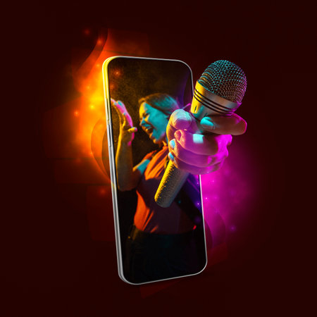 Creative art collage. Young beautiful girl hold out a hand from phone screen isolated on dark background in neon light. Concept of music, leisure time, techの写真素材