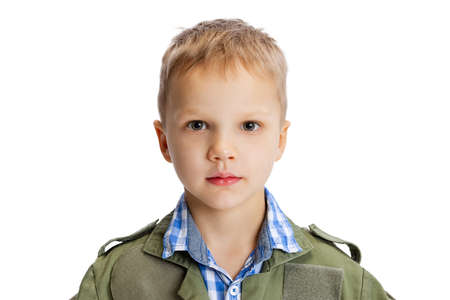 Close-up portrait of little boy, cute kid in image of auto mechanic or fitter in green dungarees with work tools isolated over white studio background. Childhood, education conceptの写真素材