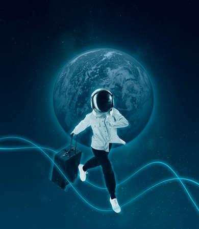 Conceptual creative artwork with young girl in helemet walking on outer space background. Concept of astronautics, dreams, astronomy, art, Day of Human Space Flightの写真素材