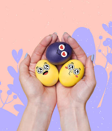 Human hands holding painted funny cute eggs in cartoon style. Happy Easter traditions, mood. Concept...