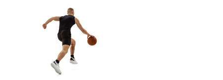 Flyer with young muscled man, basketball player running with ball isolated on white studio...