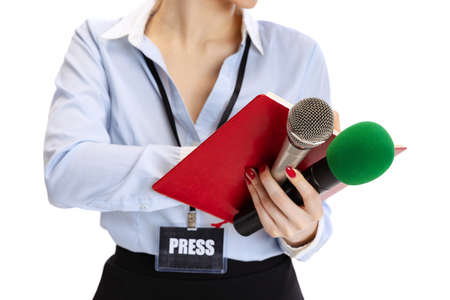 Cropped portrait of female journalist holding reporter microphones isolated on white studio background. Concept of social media, press, news, information. Close-upの写真素材