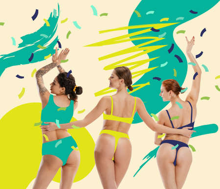 Three excited, slim girls wearing drawn colorful carnival costumes on abstract background. Concept of festival, holidiays, art, fashionの写真素材