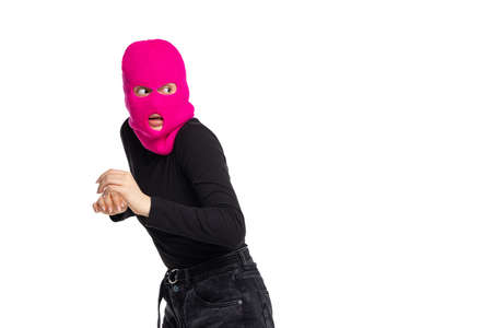 Portrait of young anonymous person wearing black outfit and balaclava isolated on white background. Concept of art, fashion, anti-terrorizmの写真素材
