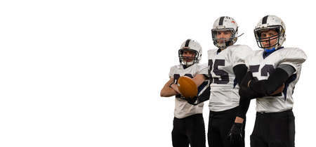 Portrait of three professional american football players in sports uniform and helmets equipment...