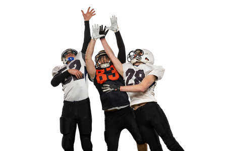 Three young sportive men, professional american football players in sports uniform and equipment in action isolated on white background. Concept of super bowlの写真素材