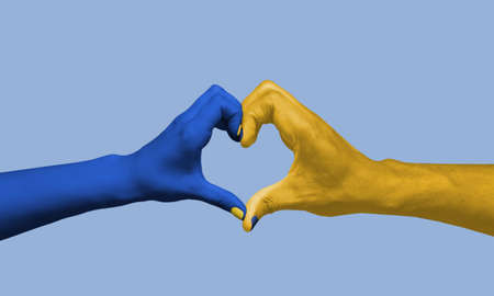 Painted in blue-yellow colors of Ukrainian flag hands gesturing isolated on bright background. Concept of help, support. Stand for Ukraineの写真素材