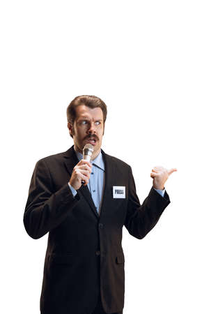 Emotive young man, professional sport commentator, journalist with microphone broadcasting football match isolated over white background. Sport, news conceptの写真素材