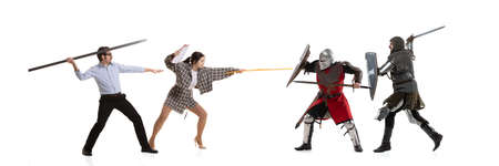 Creative collage. Battle between modern office workers and medieval knights wearing armored clothes isolated on white background. Concept of eras comparisonの写真素材