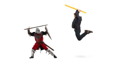 Creative collage. Fight between modern business man and medieval knight wearing armored clothes...