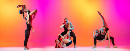 Flexible dancers, male and female models dancing contemp dance on colorful gradient yellow pink background in neon light.の写真素材