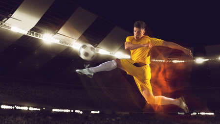 Bright dynamic collage with professional soccer, football player kick the ball in jump at dark night...