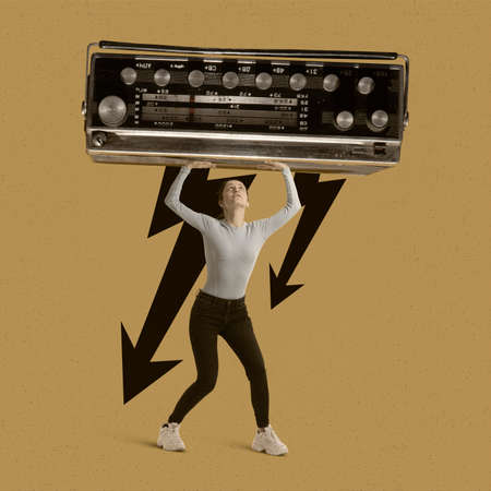 Contemporary art collage. Young woman holding giant retro radio set isolated over brown backgroundの写真素材