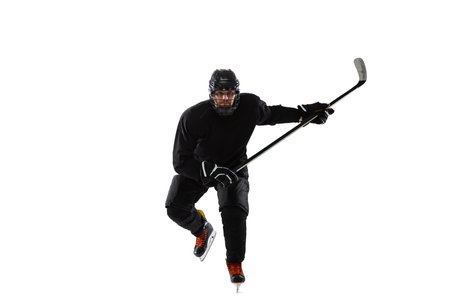 Portrait of professional male hockey player training isolated over white studio backgroundの写真素材