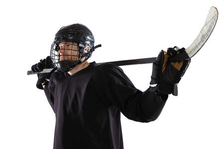 Portrait of man, professional sportsman, hockey player in black protective uniform posing isolated over white background. Trainerの写真素材