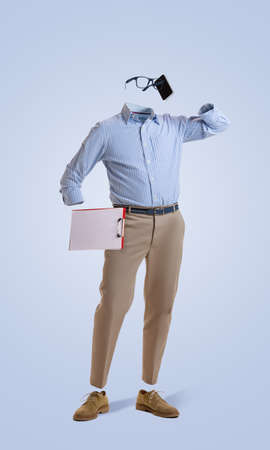 Portrait of invisible man wearing modern business style outfit talking on phone against blue background. Concept of fashion, creativityの写真素材