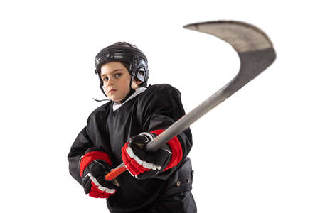 Portrait of boy, child, hockey player posing, training isolated over white studio background