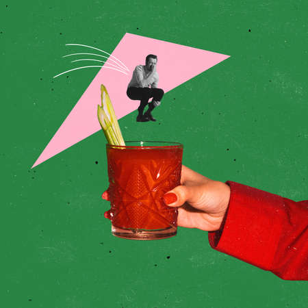 Contemporary art collage. Man jumping into Bloody mary cocktail isolated over green background. Concept of taste, alcoholic drinksの写真素材