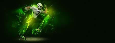 Bright poster with american football player in motion and action with ball isolated on dark background with polygonal and fluid neon elements. Art, creativity, sportの写真素材