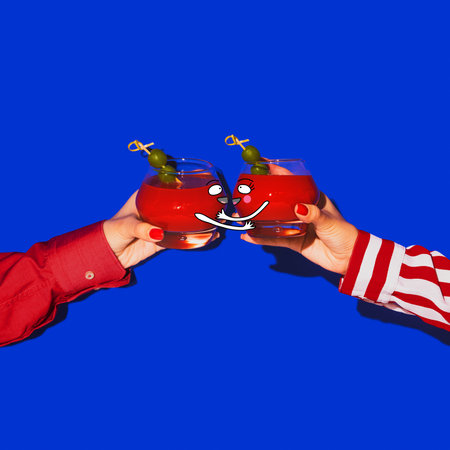 Bloody mary. Female hands holding glass with drawings with cocktail isolated on bright blue neon...