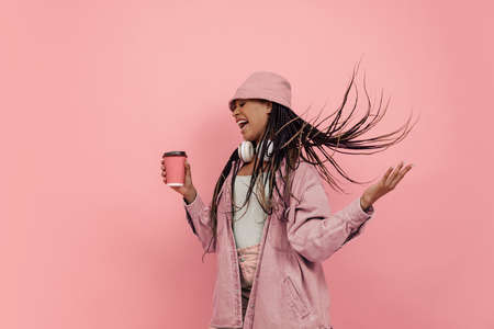 Monochrome portrait of young attractive happy woman in casual style outfit isolated on pink background. Concept of beauty, art, fashion, youth, styleの写真素材