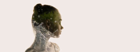 Conceptual image. Transparent silhouette of young tender woman and water splashes around grass...
