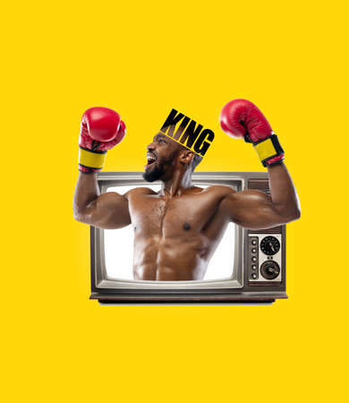 Happy strong man, boxer sticking out from retro tv set isolated on yellow background. Contemporary art collage. Concept of art, surrealism, news, sportの写真素材