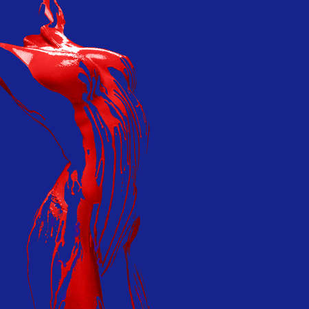 Contemporary body art. Cropped female invisible body, breast and shoulders covered with red paint, dye isolated over blue background. Concept of creativity, beauty.の写真素材
