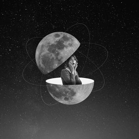 Contemporary art collage. Shocked young woman sticks out from split planet isolated on dark starry background. Monochrome. Minimalismの写真素材