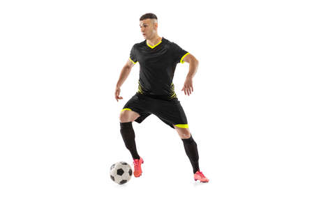 Professional male football soccer player in motion and action isolated on white studio background. Concept of sport, goals, competition, hobbyの写真素材