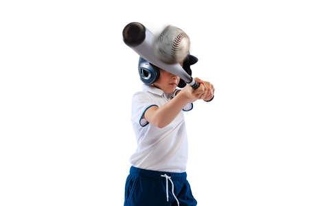 Little beginner baseball player in sports uniform playing baseball isolated on white background. Concept of sport, achievements, competitionの写真素材