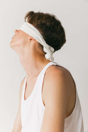 Handsome man with closed eyes isolated on white studio background. Concept of fashion, youth,...