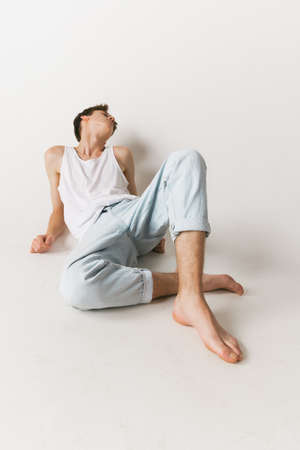 Wide angle view of young man in jeans and t-shirt isolated on white studio background. Concept of fashion, youth, emotions, facial expression, adの写真素材
