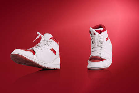 Modern unisex footwear, sneakers isolated on red background. Fashionable stylish sports casual...