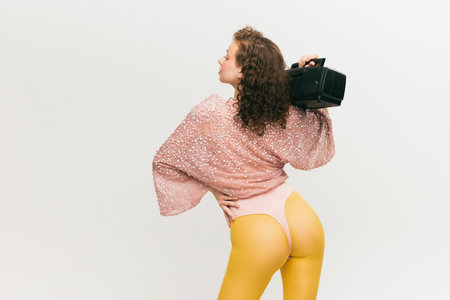 Closeup. Back view of young fashionable girl in  style outfit over white background. Vivid style, beauty, queer, freak, fashion concept.の写真素材
