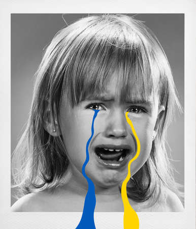 Sad little Ukrainian girl with tears from Ukrainian flag colors on her face. Children asking for peace. Concept of participation of Ukrainian people in war with Russia.の写真素材