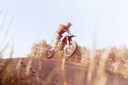 Live shot of professional motorcycle rider training on Enduro motorcycle at steppe or desert area, outdoors at hot summer day.のeditorial素材