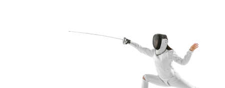One sportsman, female fencer in white fencing costume in action, motion isolated on white...