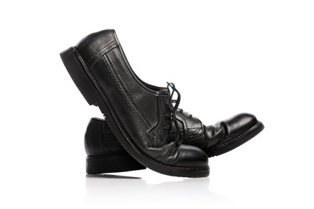 Old black mans shoes isolated over white background. Vintage classic style footwear. Concept of ad, sales , 60s, 70s fashion. Timeless classicの写真素材