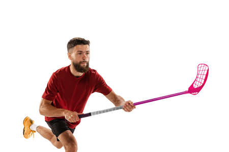 Dynamic portrait of male floorball player with floorball stick in action isolated on white background. Sport, competition and motion, movement, active lifestyleの写真素材