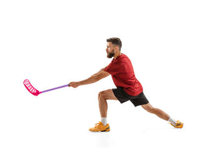 Dynamic portrait of male floorball player with floorball stick in action isolated on white background. Sport, competition and motion, movement, active lifestyleの写真素材
