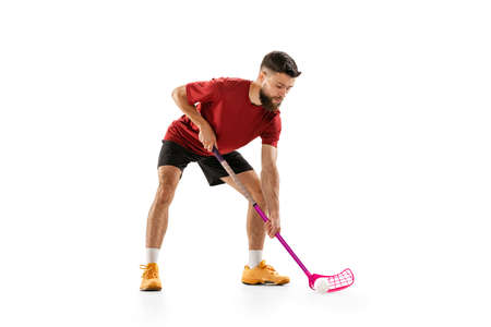 Dynamic portrait of male floorball player with floorball stick in action isolated on white background. Sport, competition and motion, movement, active lifestyleの写真素材