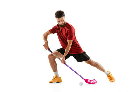 Floorball male player with floorball stick training isolated on white studio background. Sport,...