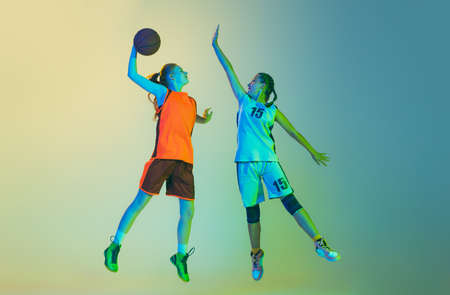 Attack and defense. Female basketball players, young girls, teen in action with basketball ball...