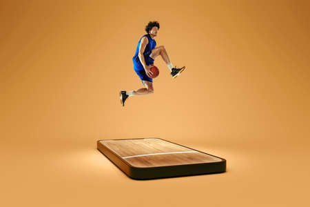 Professional basketball player playing basketball on 3d device screen over brown color background. Sport games, online watching sports events. Collageの写真素材
