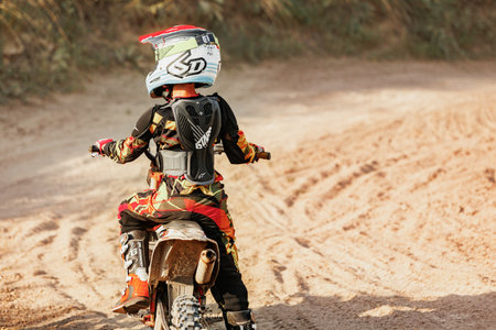 Dnipro, Ukraine JULY 01, 2022. Ukrainian beginner motorcycle rider driving on Enduro motorbike,...