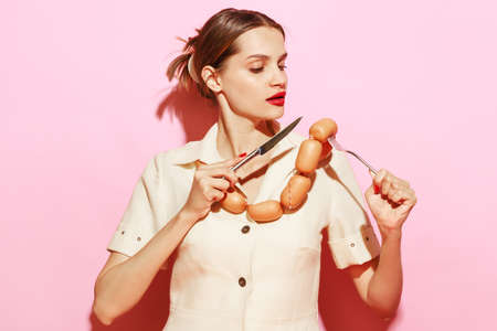Image of woman having necklace made from sausages. Creative food advertisement. Eatingの写真素材