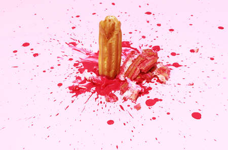Image of delicious french eclair with strawberry filling cream isolated over pink background