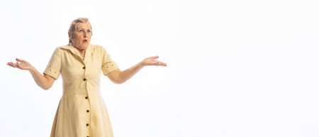 Surprised senior woman in retro vintage style outfit posing isolated on white background. Concept of...