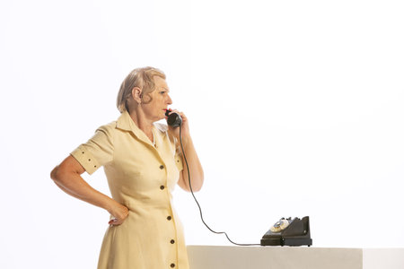 Portrait of annoyed senior woman in retro vintage style outfit posing isolated on white background. Concept of beauty, old generation, fashion, emotionsの写真素材